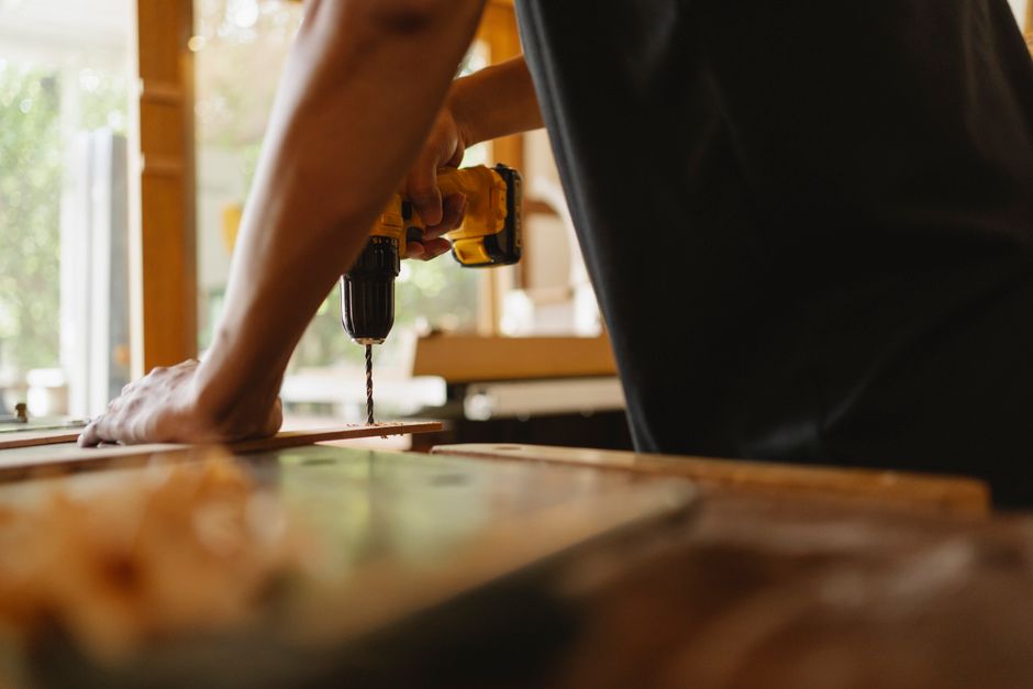 Craftsman installing wooden custom cabinetry